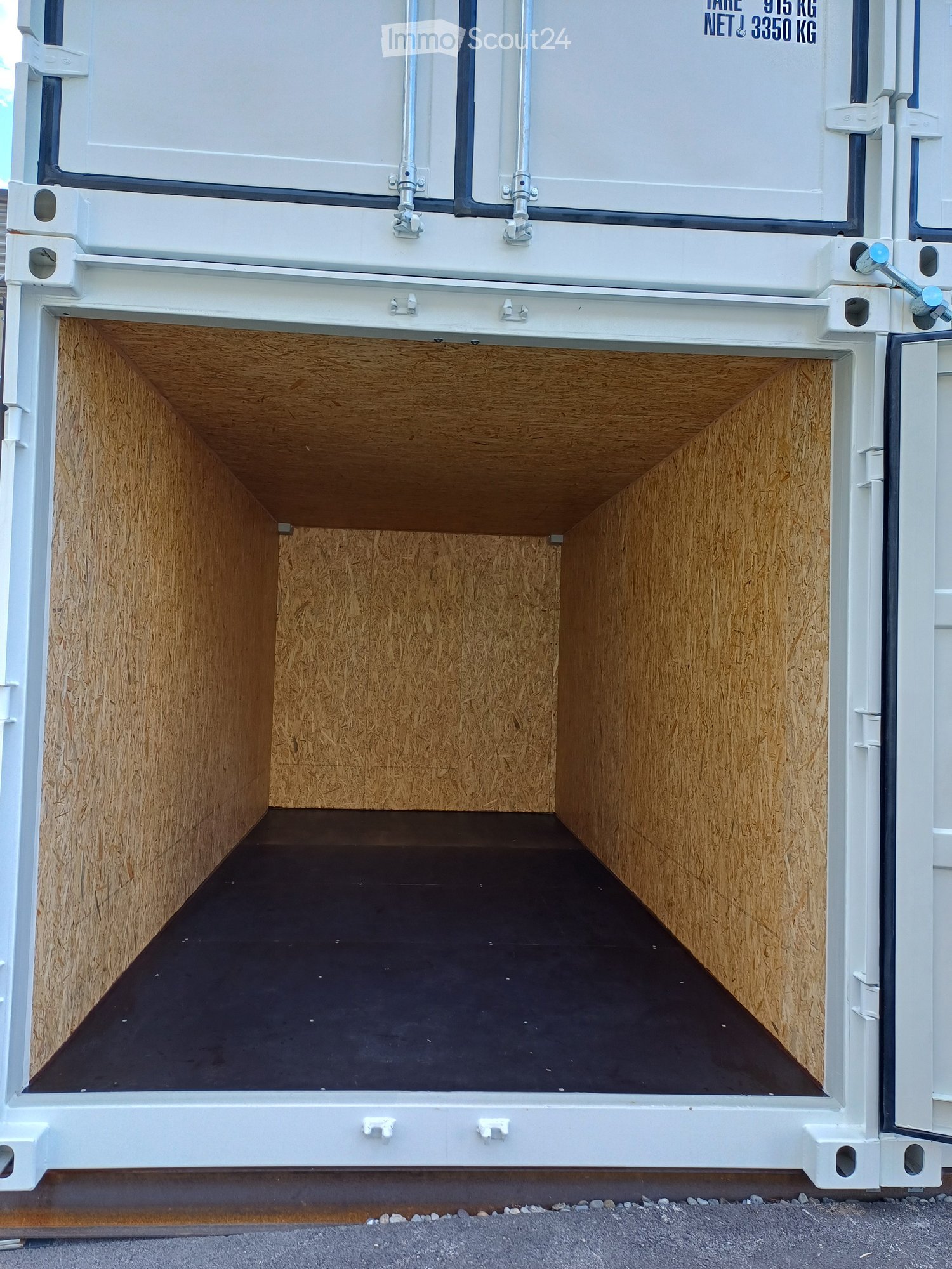 Empty container with wooden walls and black floor