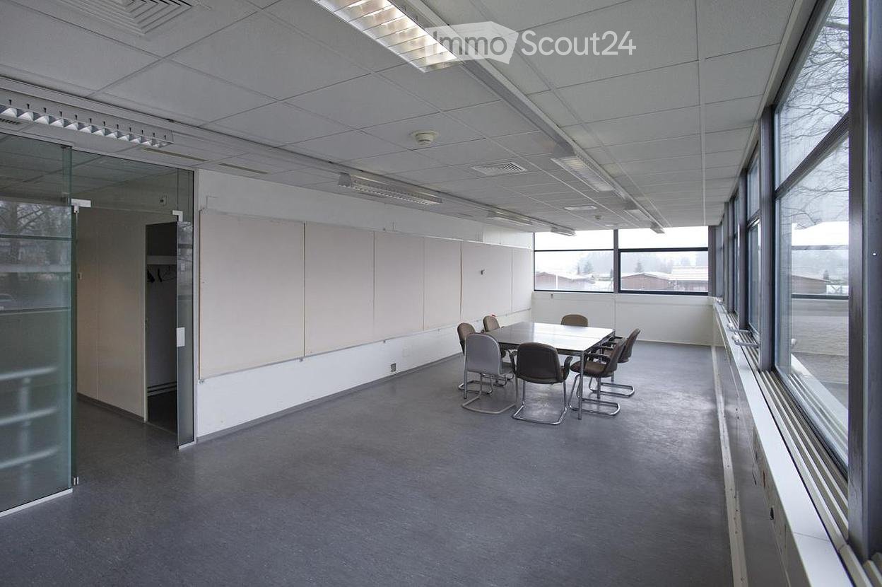 empty meeting room with large windows and grey floor