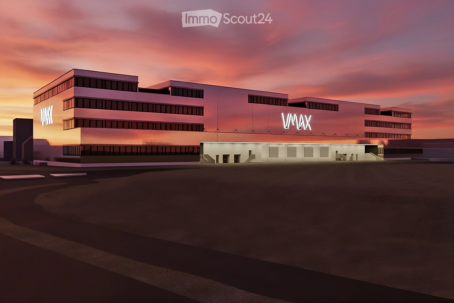 Modern building with multiple floors, glass windows, central entrance, illuminated at dusk