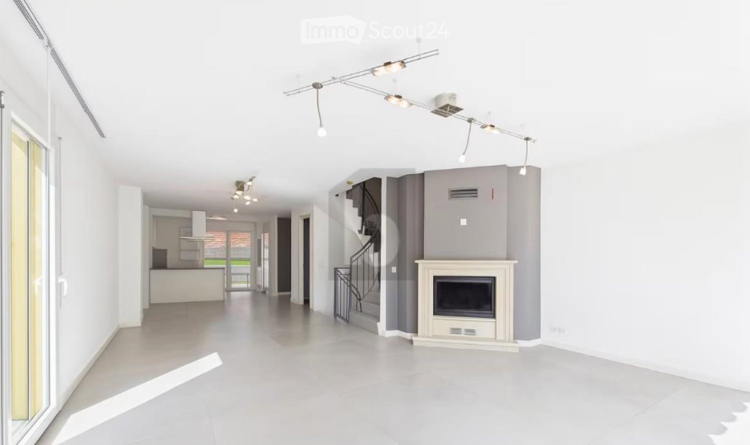 Empty room with staircase, fireplace, sliding glass door, and tiled floor