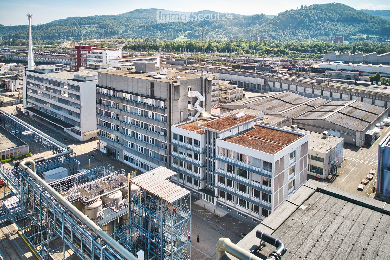 Large industrial complex with several buildings, metal structures, and machinery equipment.
