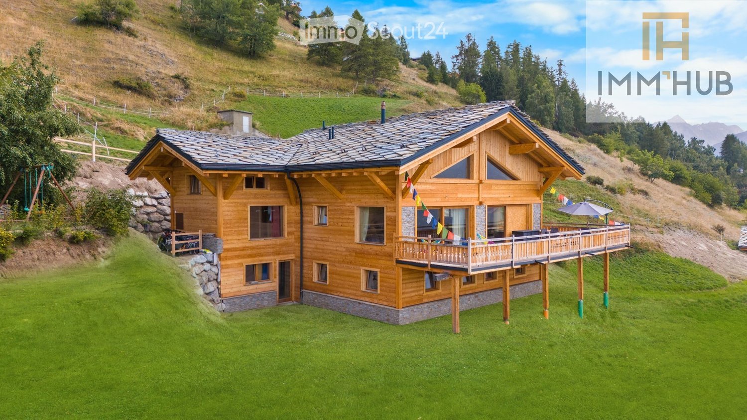 wooden chalet on hill, 2 stories, large terrace with umbrella, sloping grounds, lawn