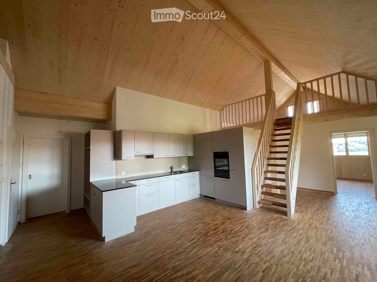 wooden ceiling, wooden floors, white kitchen with granite countertop, modern appliances, white stairs leading up