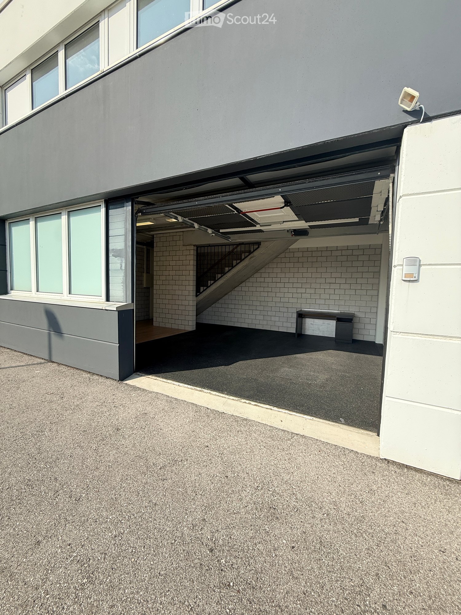 Open garage with brick walls and staircase