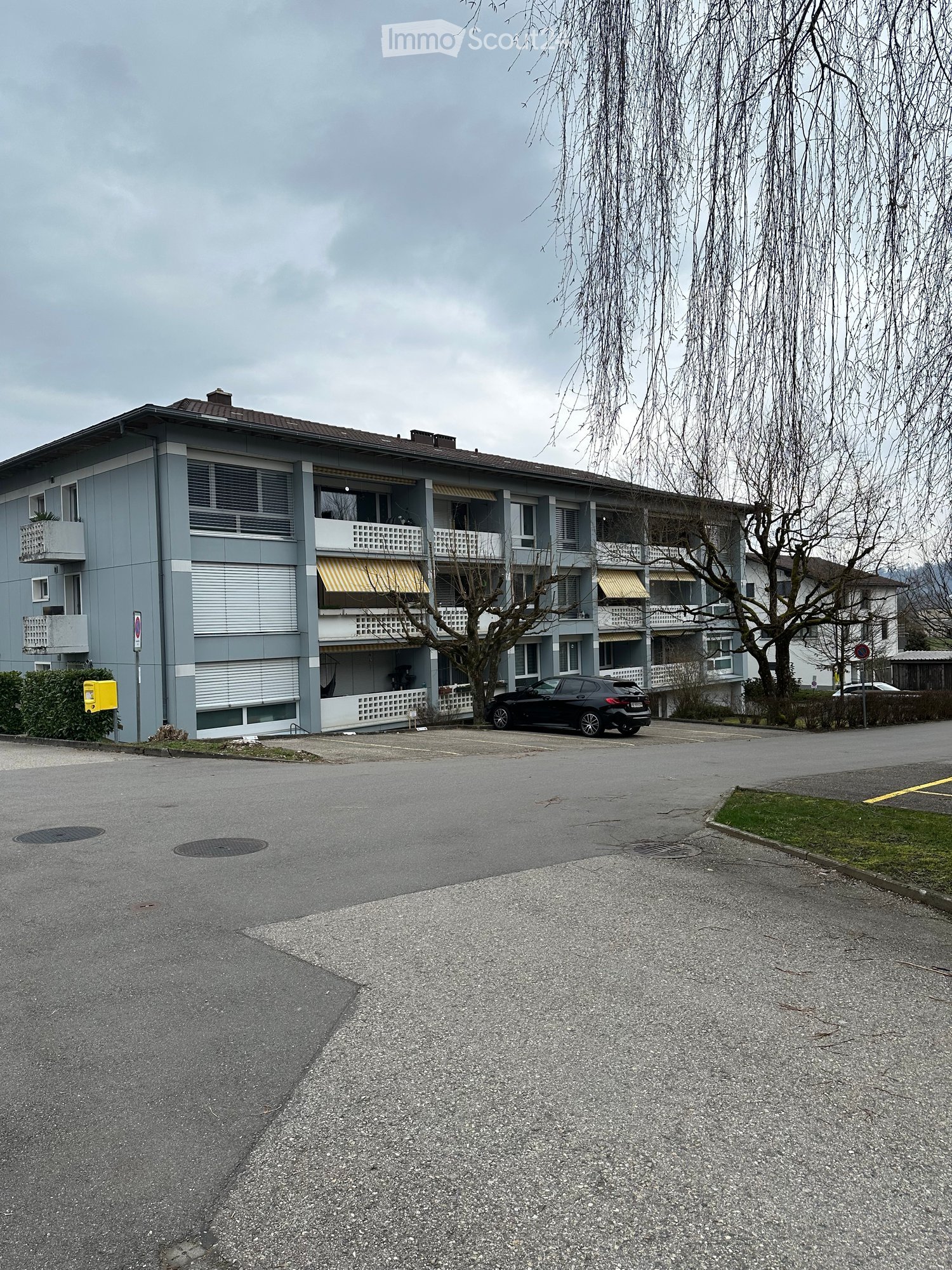 An apartment building with a parking space in front of it