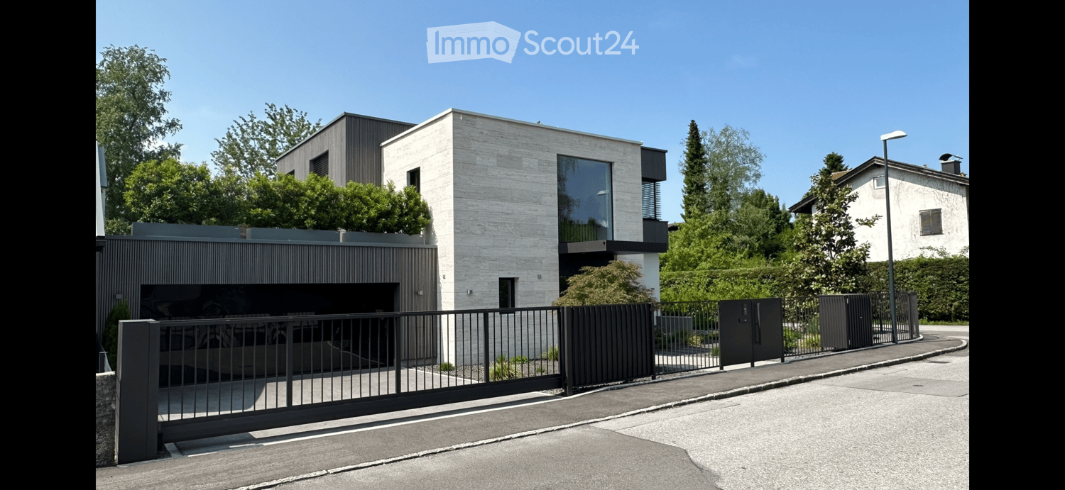 two-story modern design house with garage, modern facade with glass wall, plants and trees around