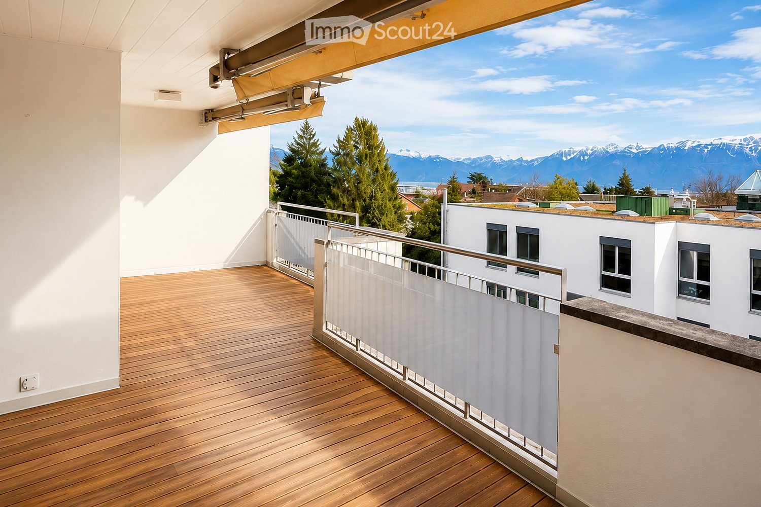 Balcony / Terrace. Balcony with wooden decking, white railing, and scenic mountain view.