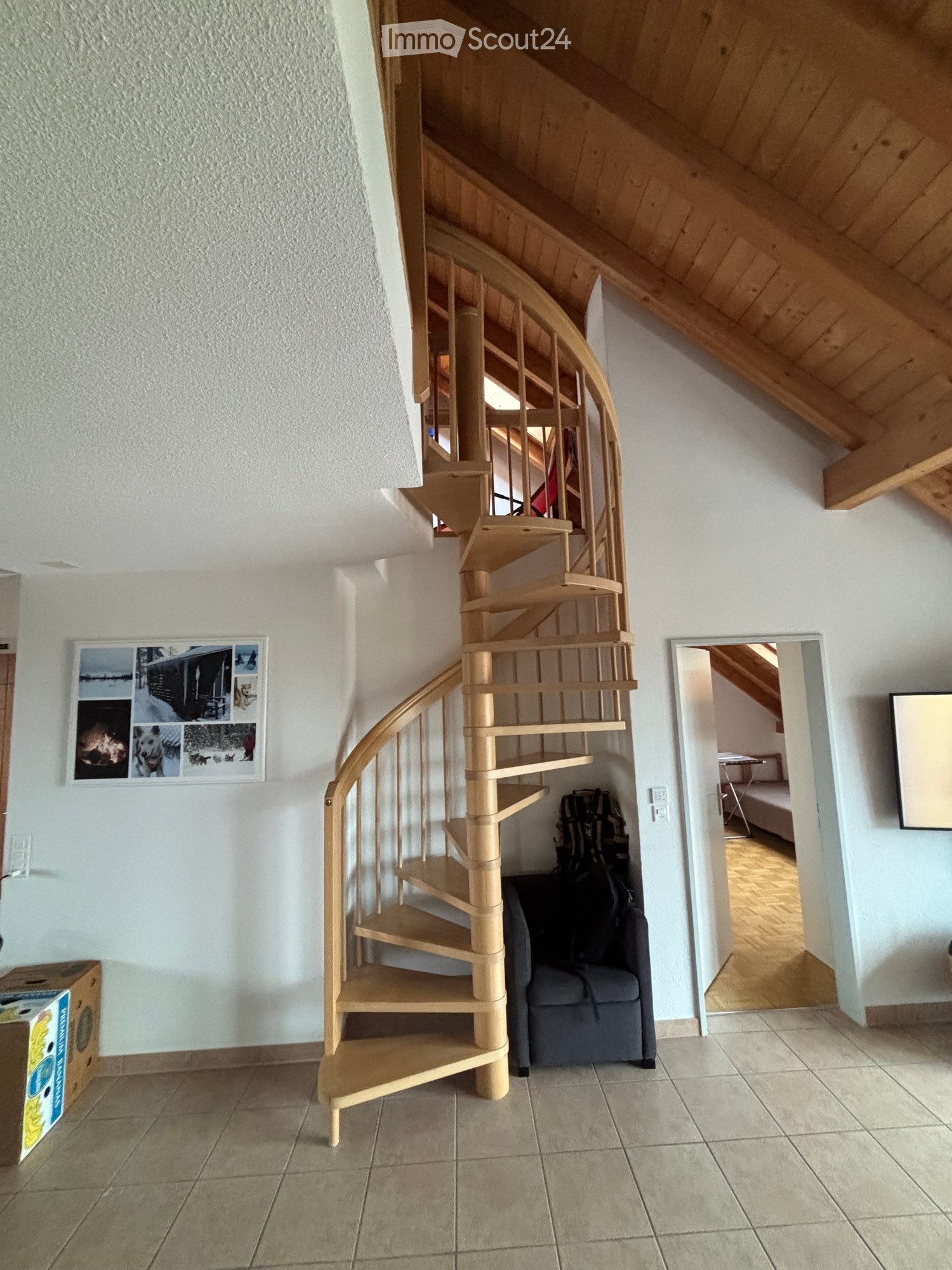 Living room with spiral staircase leading to upper floor