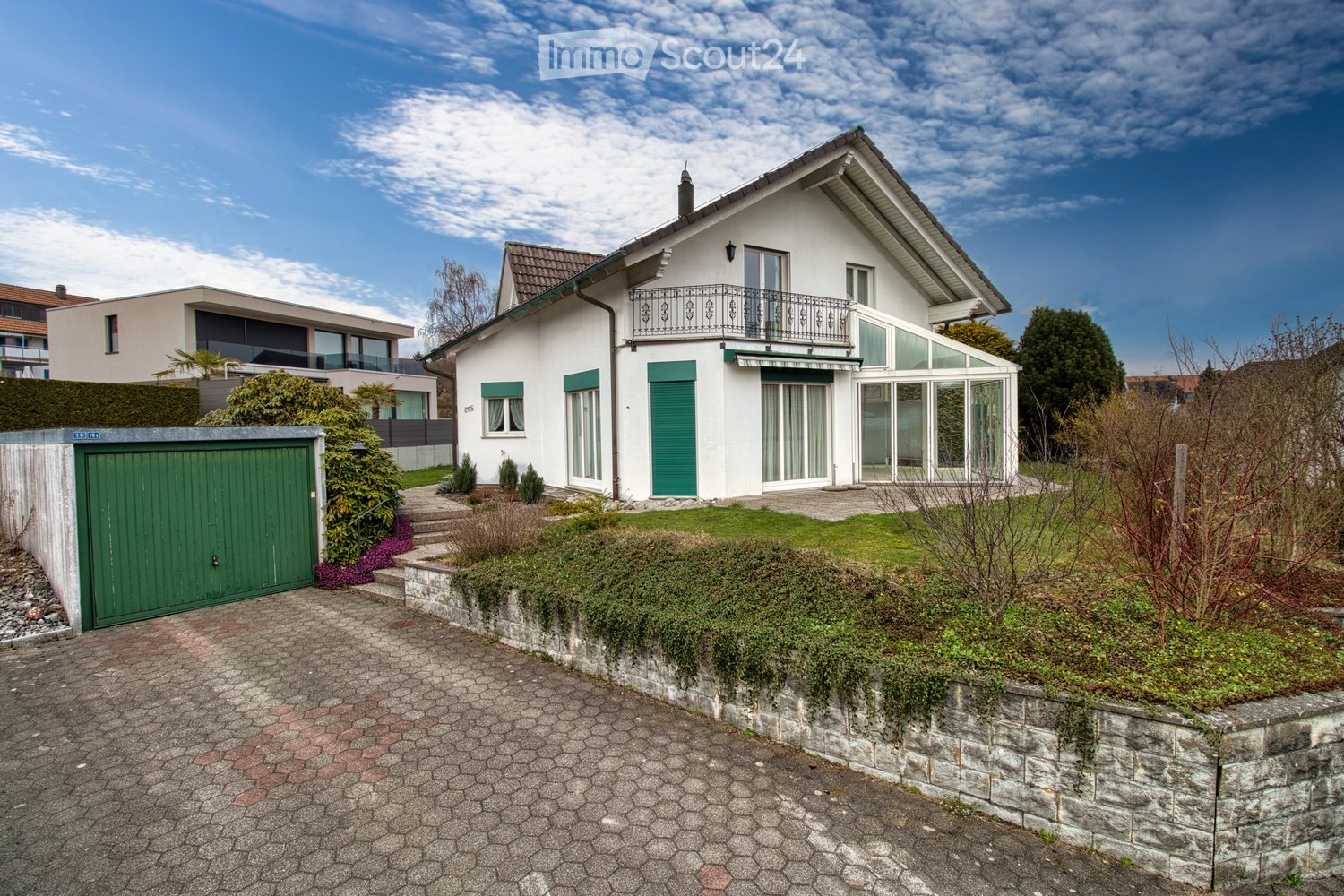 two story house, white exterior, green shutters, balcony, garage, driveway