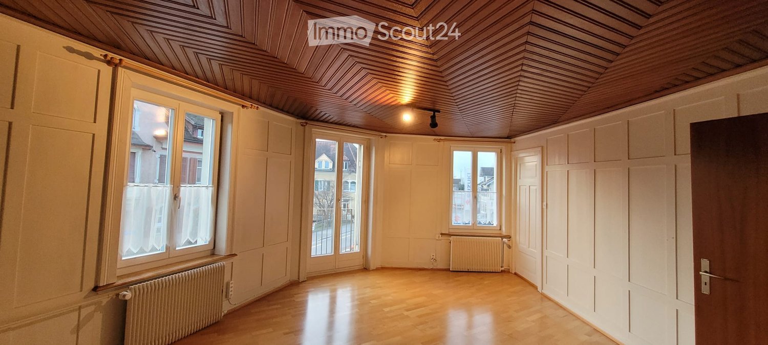 empty room, wooden floor, white walls, wooden ceiling, windows, radiators