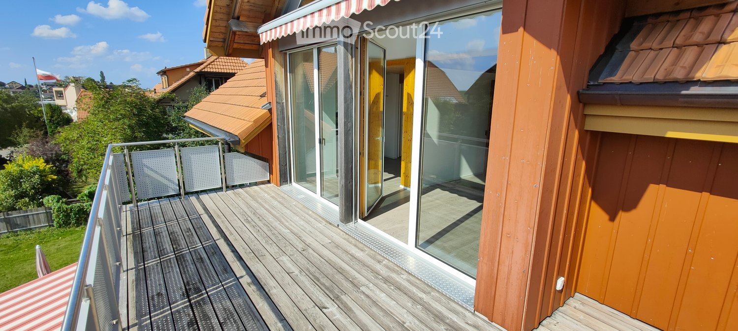 wooden floor, metal railing, glass doors, striped awning