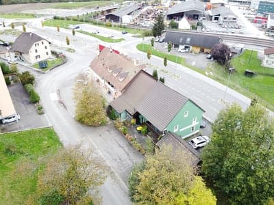 Small town aerial view with residential homes, parking, greenery and roads