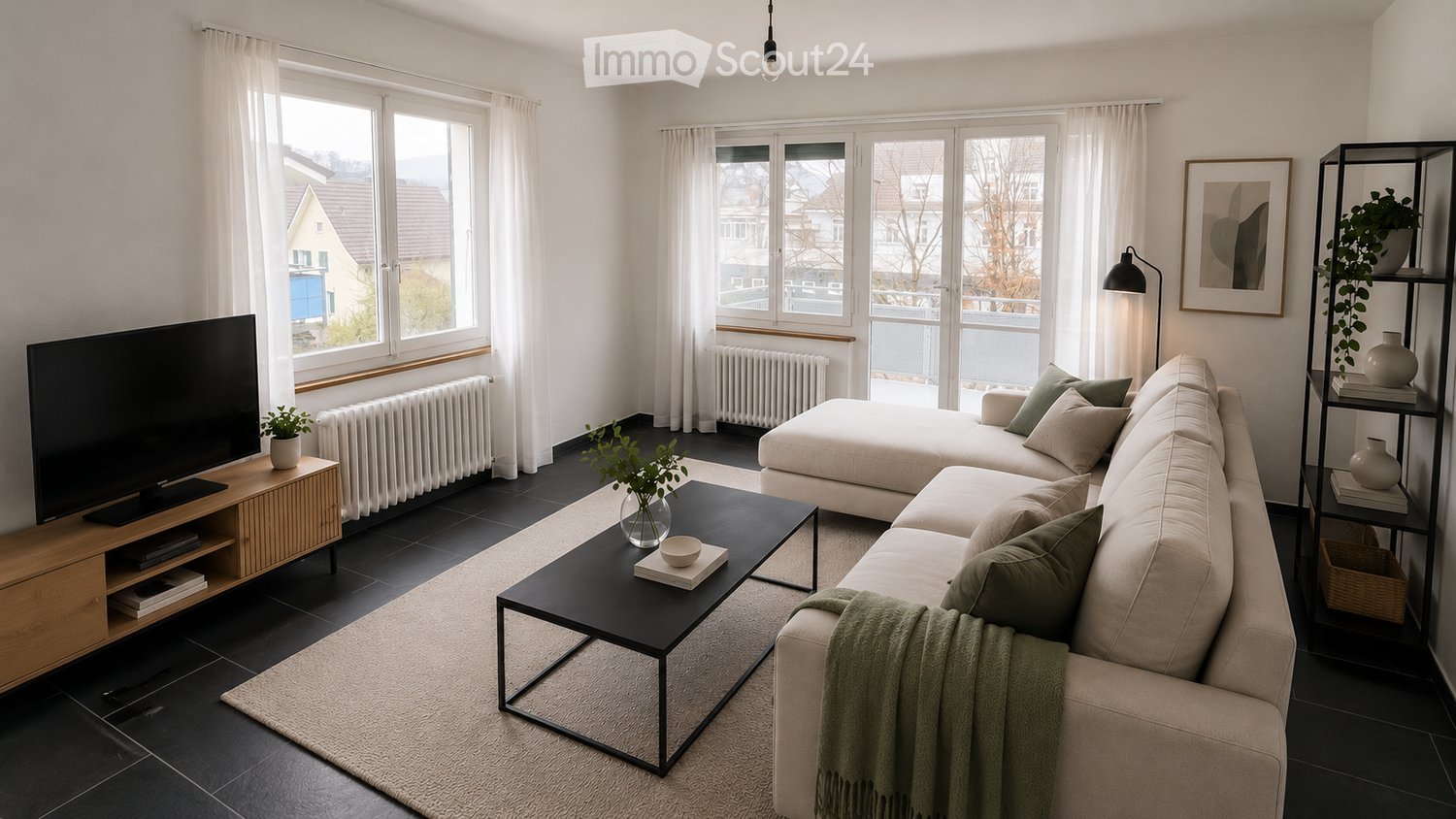 Modern living room with large windows, a sectional sofa, coffee table, TV stand, floor lamp, and decorative plants.