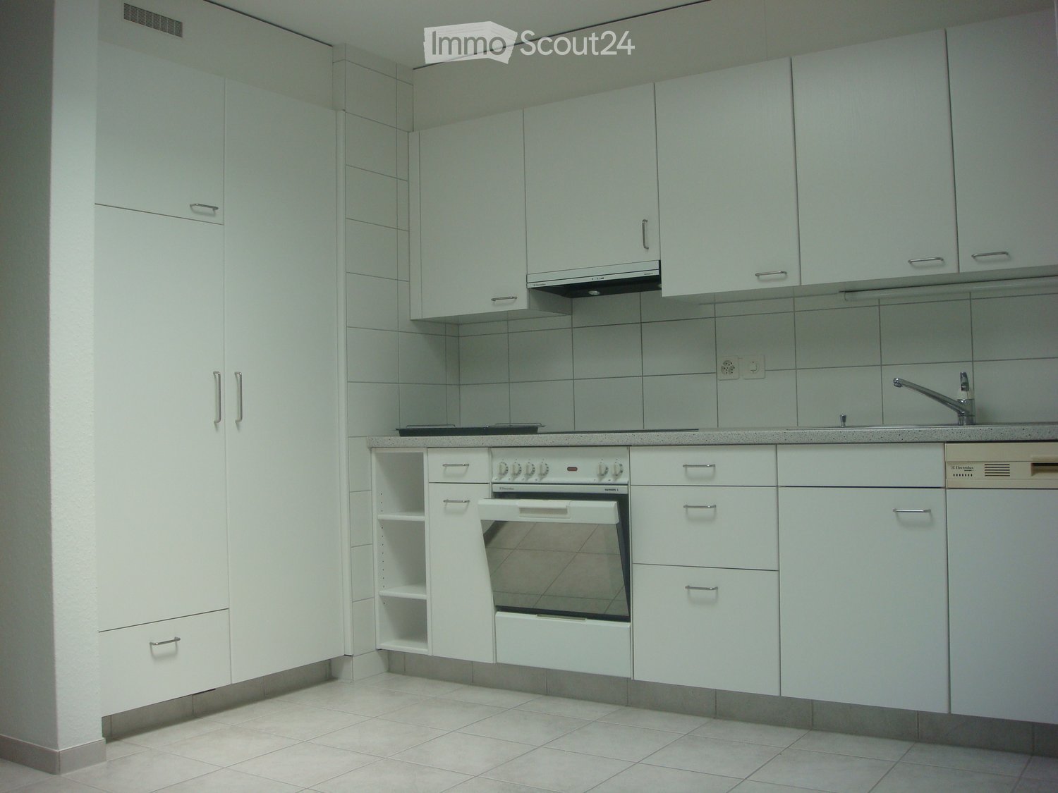 modern kitchen with white cabinets, tiled floor, gas stove, oven, dishwasher, sink, faucet