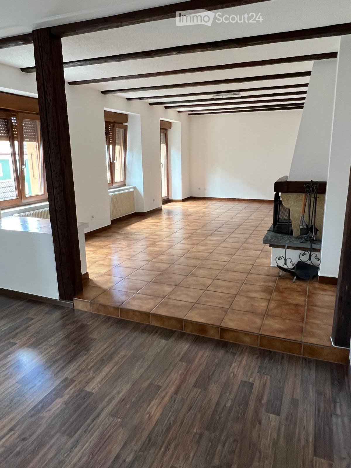 empty room, wooden floor, tiled floor, fireplace, windows, wooden beams