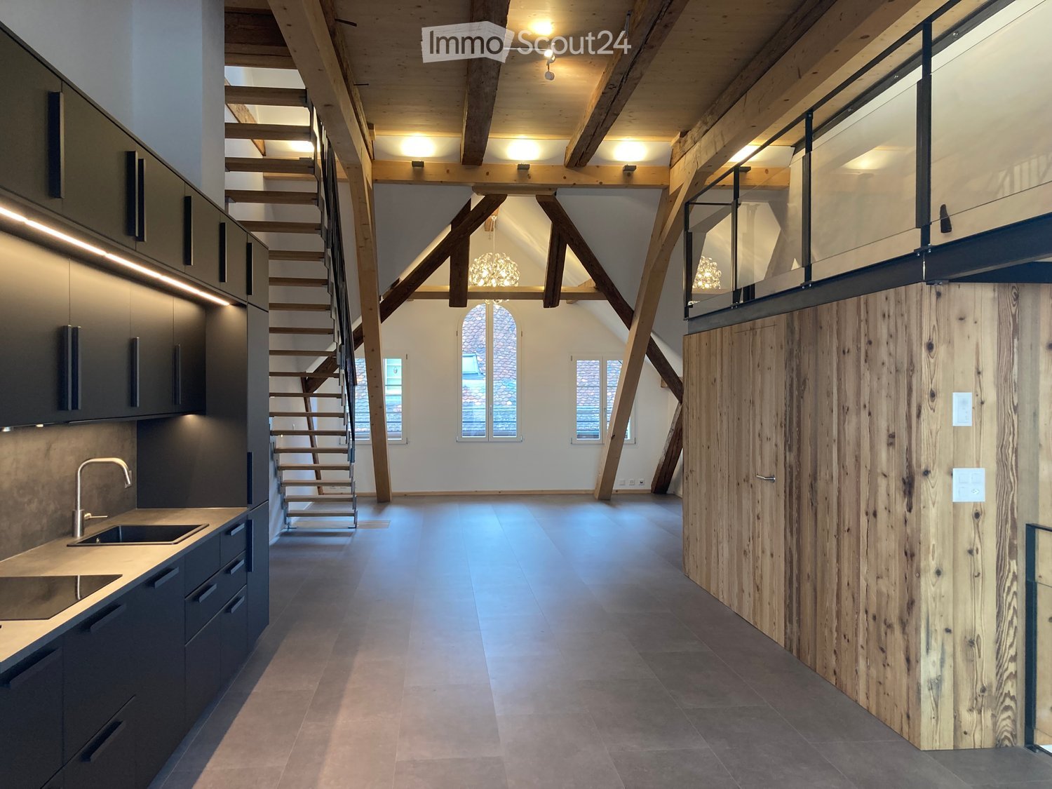 modern kitchen with wooden beams, gray tiles, gray cabinets, sink, faucet, staircase