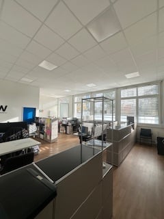 modern office, white walls, wooden floor, large windows, desks, chairs, equipment