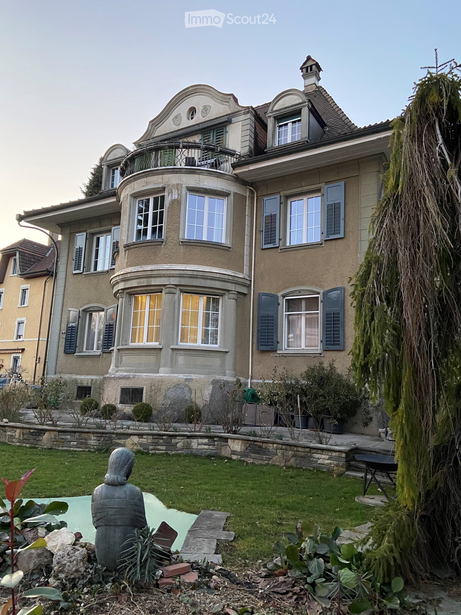 3 story house, beige exterior, multiple windows, balcony, garden, pool