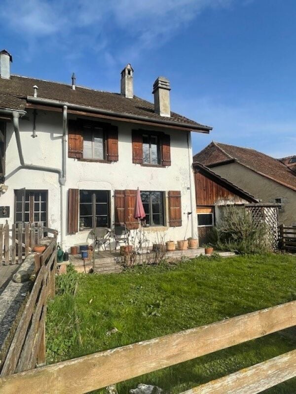 2 story house, white exterior, brown roof, wooden shutters, balcony, garden, wooden fence