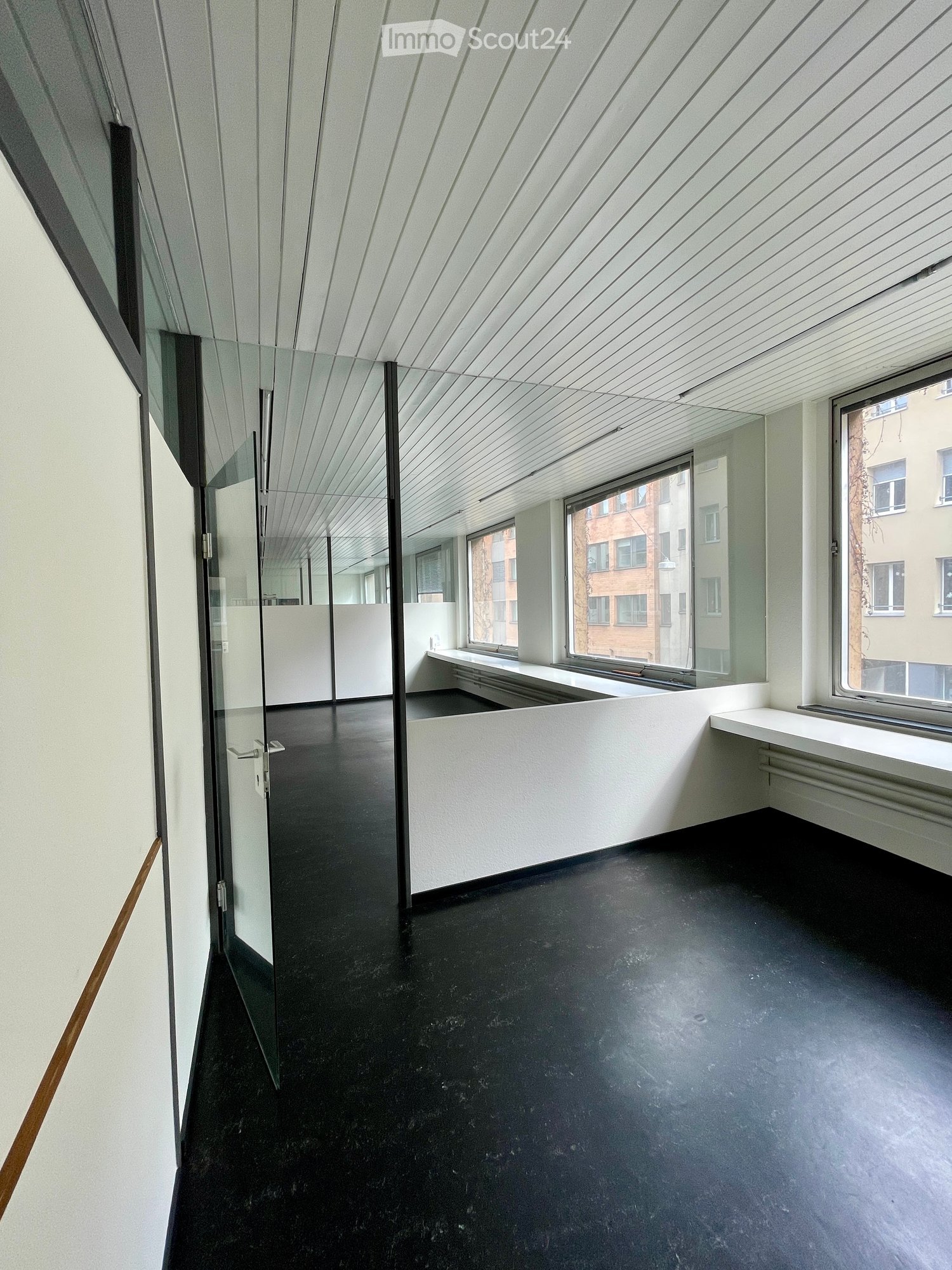 empty room, glass walls, black floor, white walls, large windows