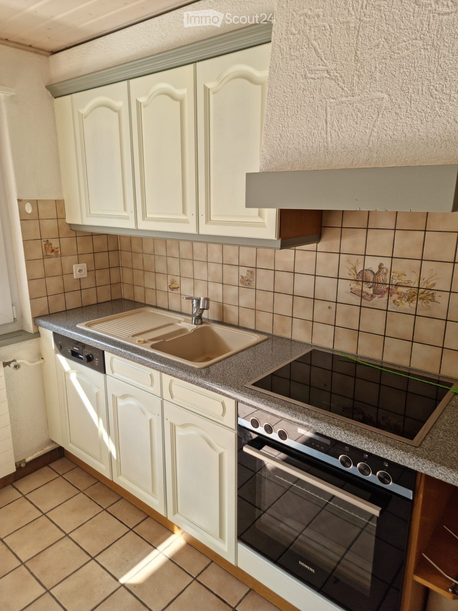 kitchen with white cabinets, tiled floor, tiled backsplash, double sink, dishwasher, oven, stovetop