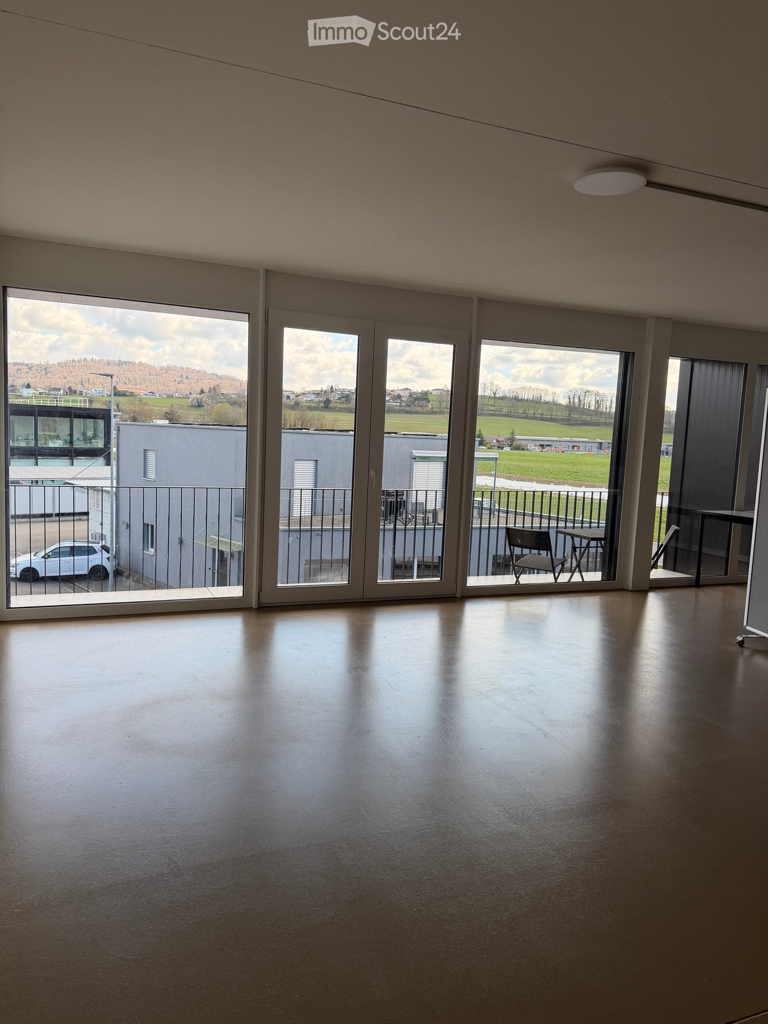 large windows, balcony, view of the outside, empty room