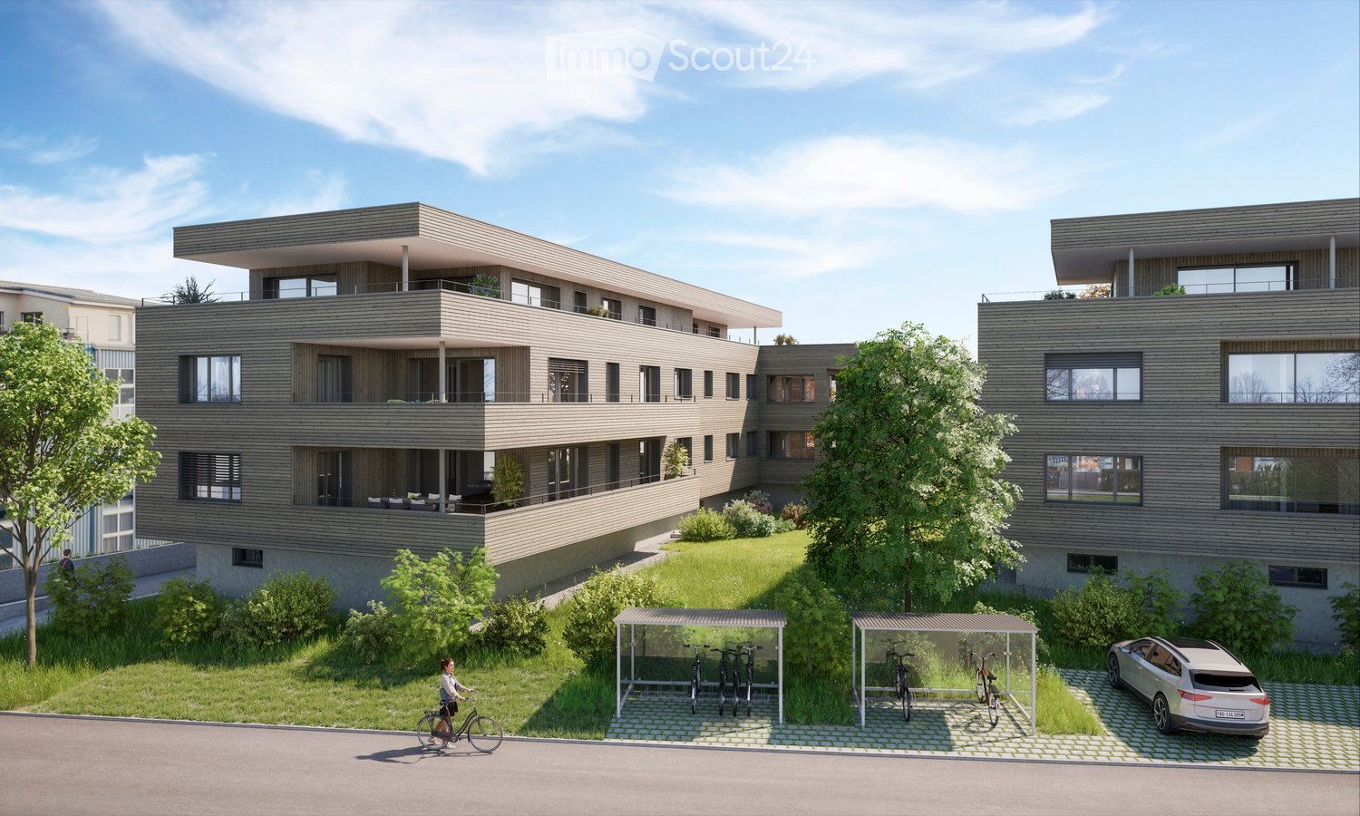Modern apartment building with balconies, landscaped garden, bicycle parking, and a car parked in front.