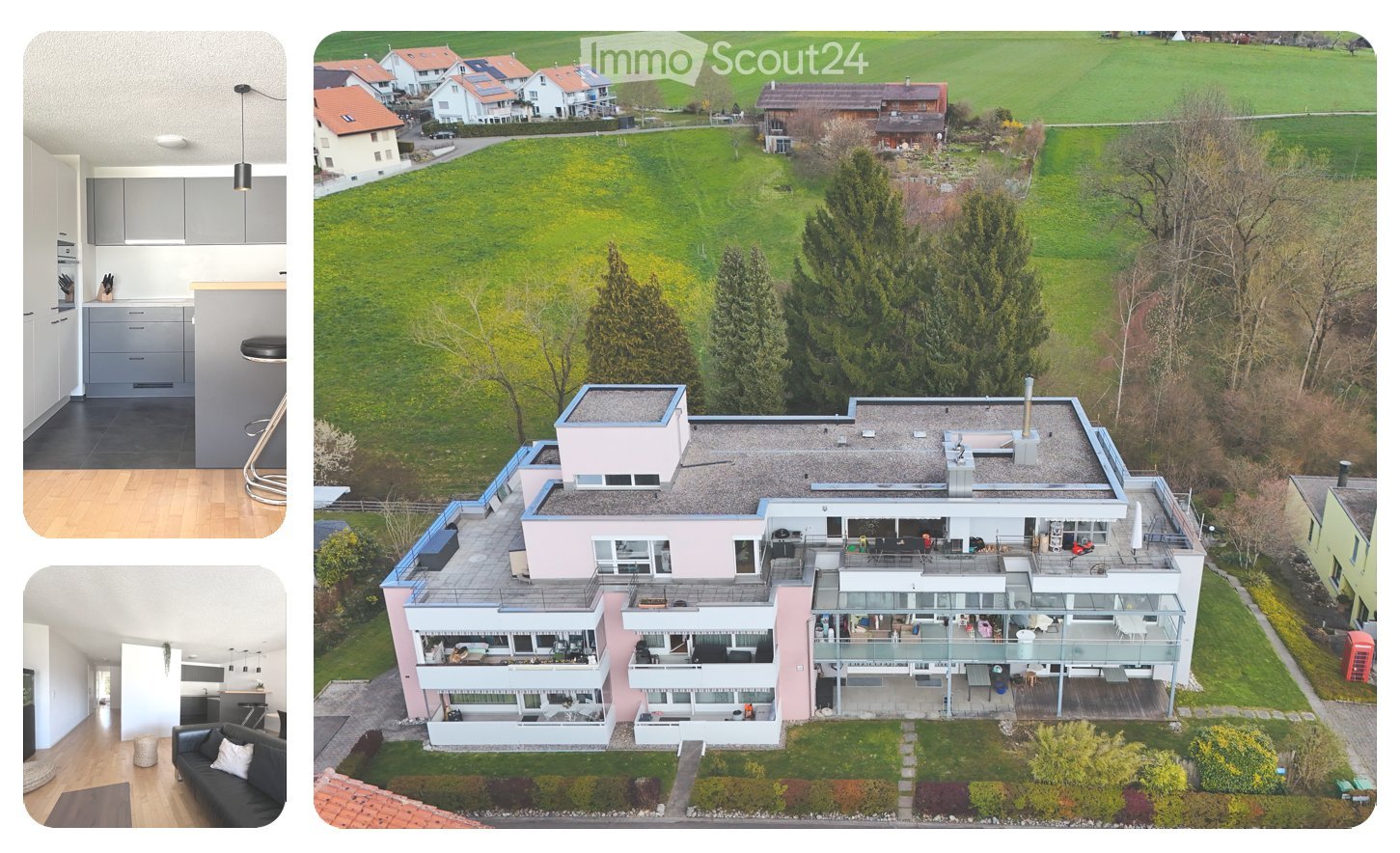 Aerial view of a modern apartment building with multiple balconies, surrounded by a green field and trees, with a clear view of the surrounding landscape.