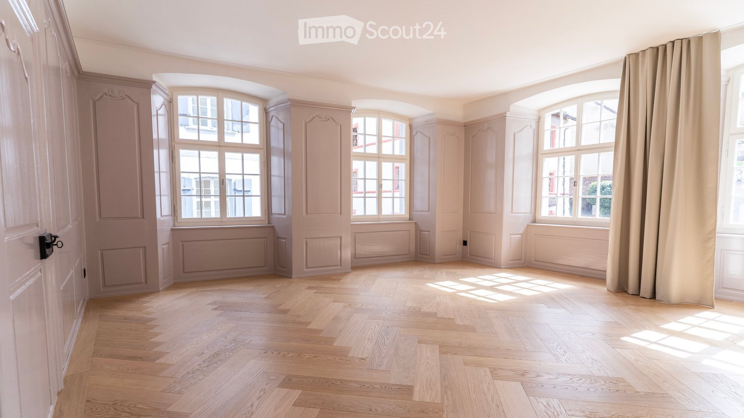 empty room, wooden parquet floor, three arched windows, white walls, beige curtains