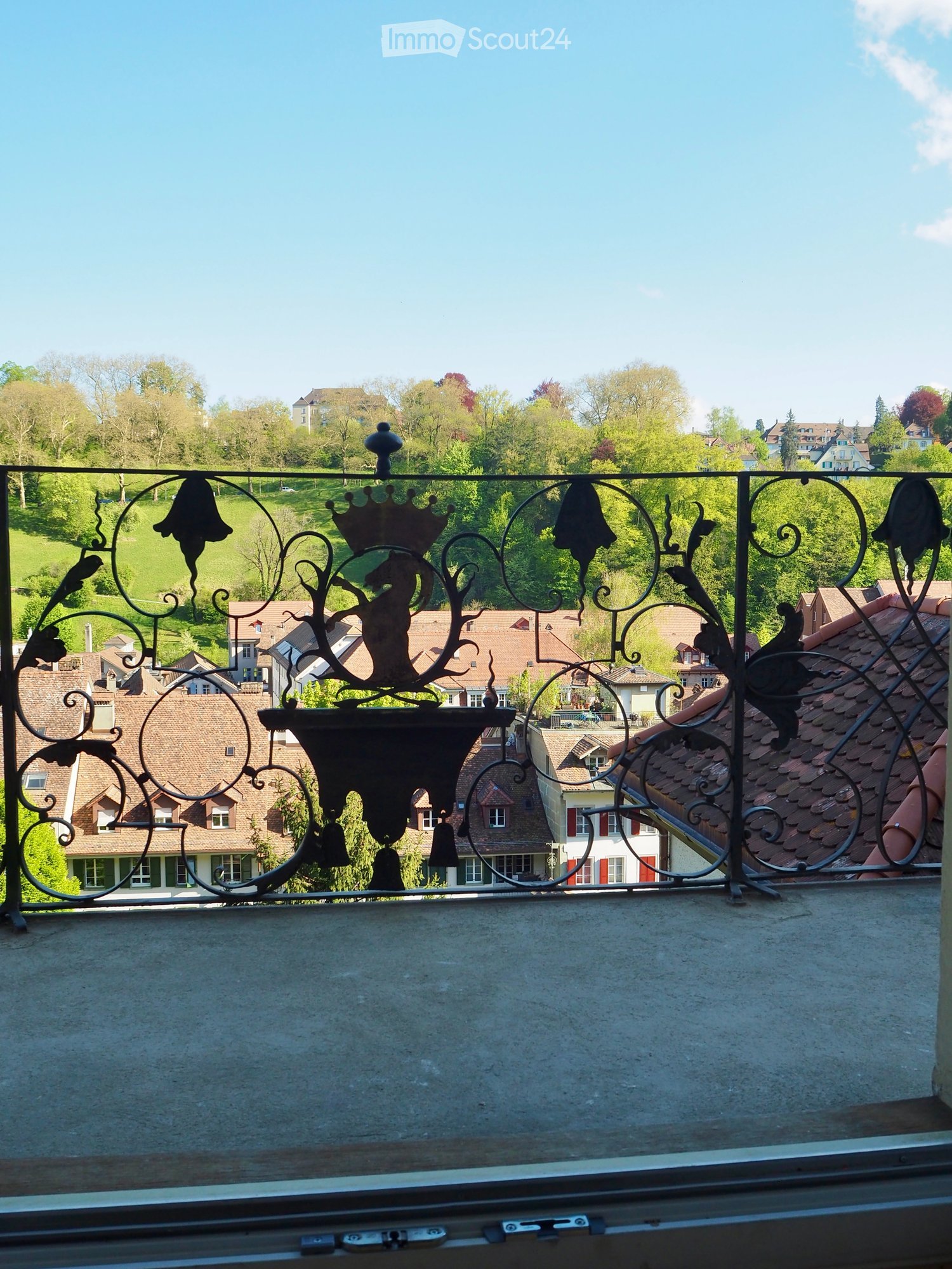 Balcony with wrought iron railings, view of the town