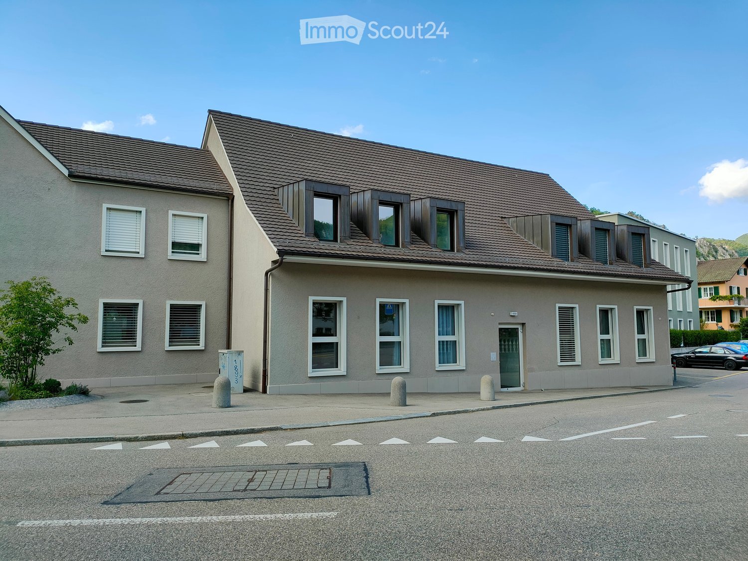 2 story house, gray exterior, brown roof, multiple windows, entrance door, street view