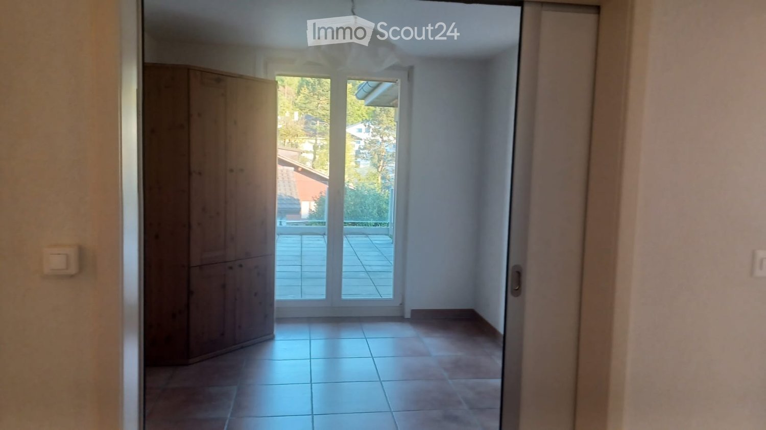 empty room, wooden cabinet, sliding glass door, balcony, tiled floor
