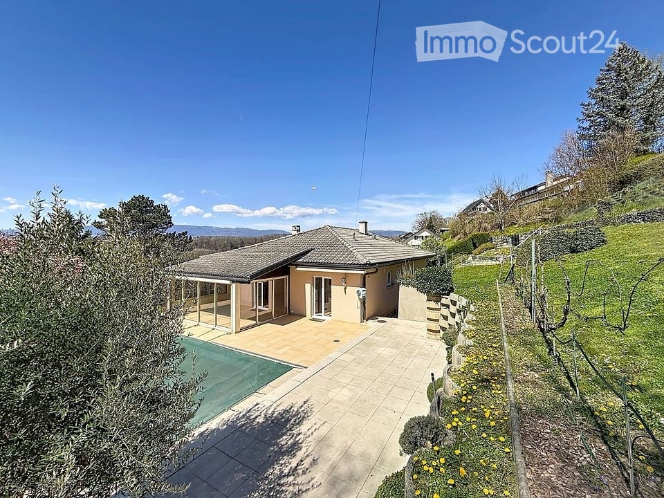Detached house, tiled roof, glass doors, swimming pool, paved patio, garden, trees, hillside