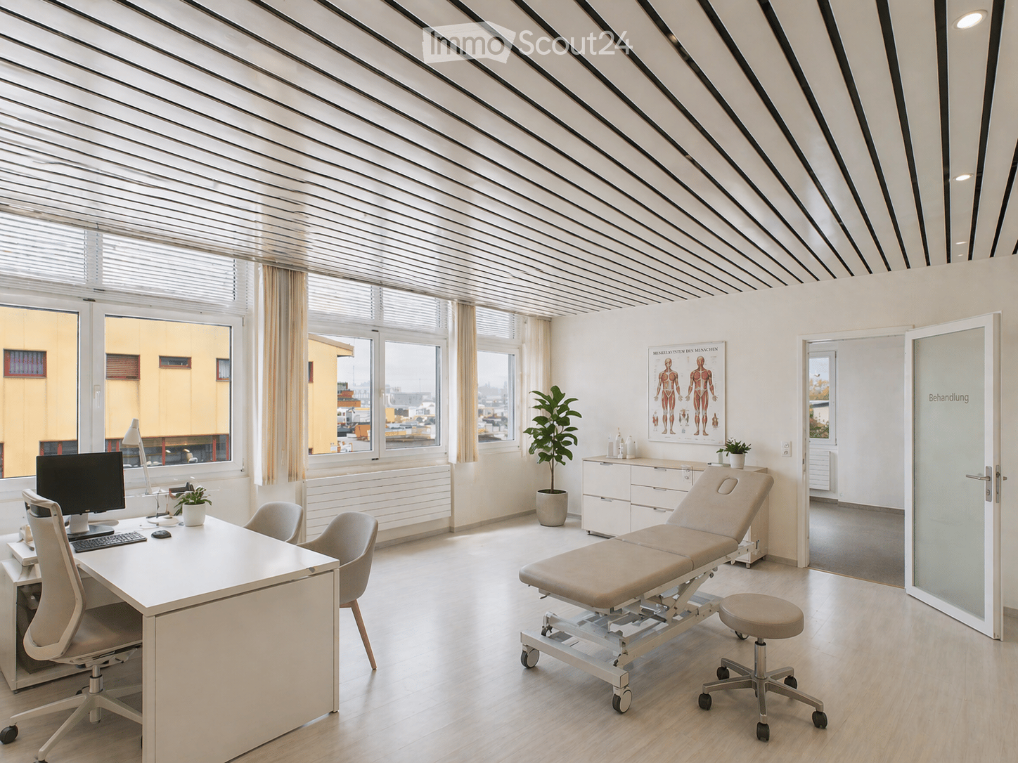 Office room with desk, chairs, monitor, keyboard, mouse, potted plants, medical equipment, windows, radiator, cabinet, poster
