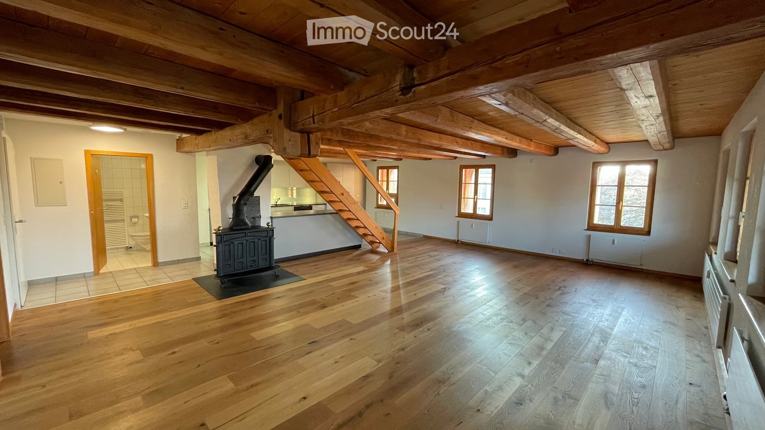 wooden ceiling, wooden floor, fireplace, open kitchen, stairs
