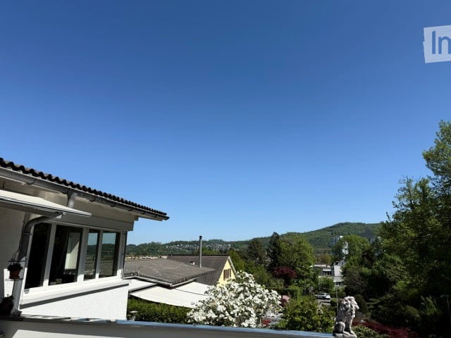 Balcony / Terrace. Balcony with a view of a suburban neighborhood, trees, and distant hills under a clear blue sky.