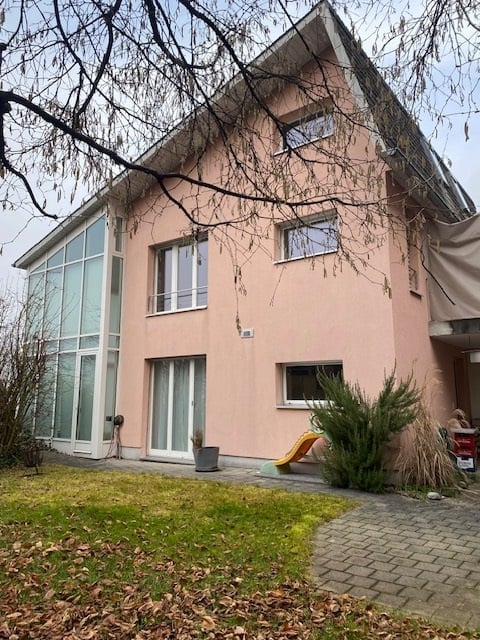 two story house, pink paint, glass windows, grass in front
