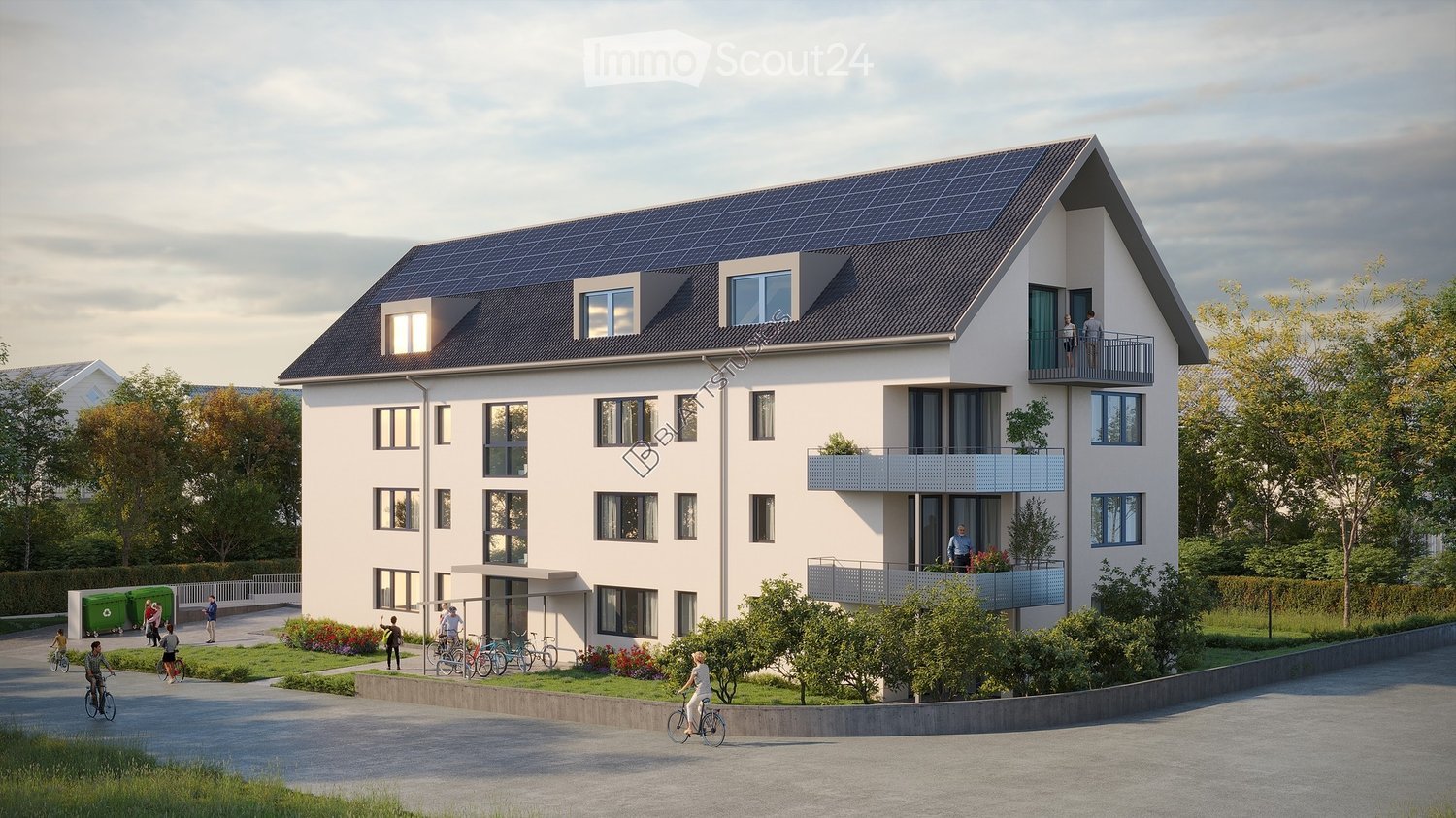 Building. Modern two-story residential building with white facade, multiple windows, balconies, and solar panels on the roof. The building is surrounded by greenery and a paved driveway.