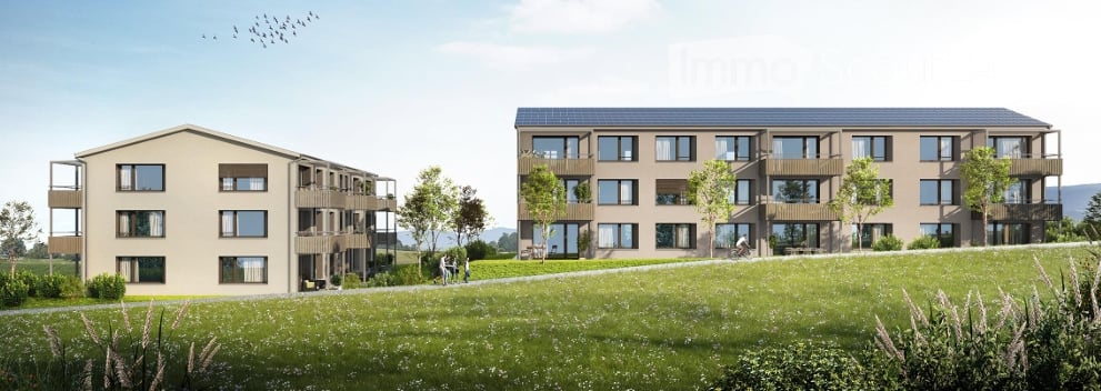 Building. Two modern apartment buildings with balconies and large windows, surrounded by a green field and trees.