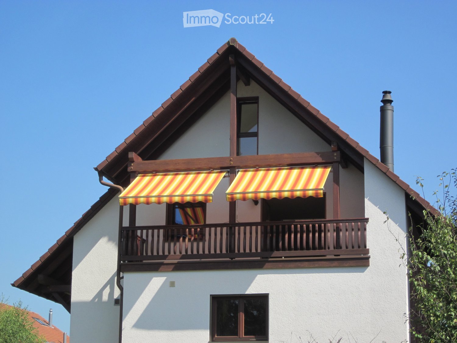 white exterior, brown roof, balcony with awnings, chimney, small window on the second floor