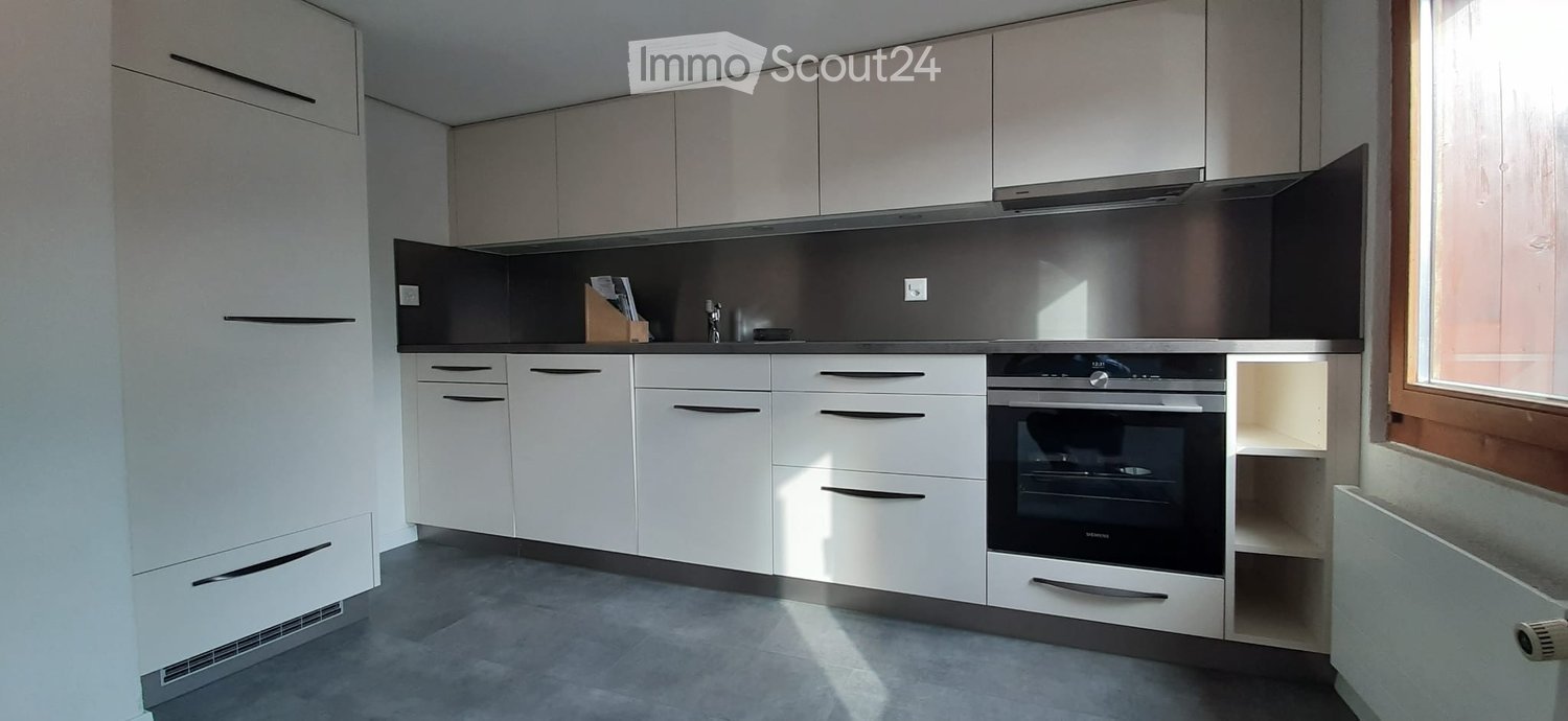 Kitchen. Modern kitchen with white cabinets, stainless steel oven, and sleek countertops.