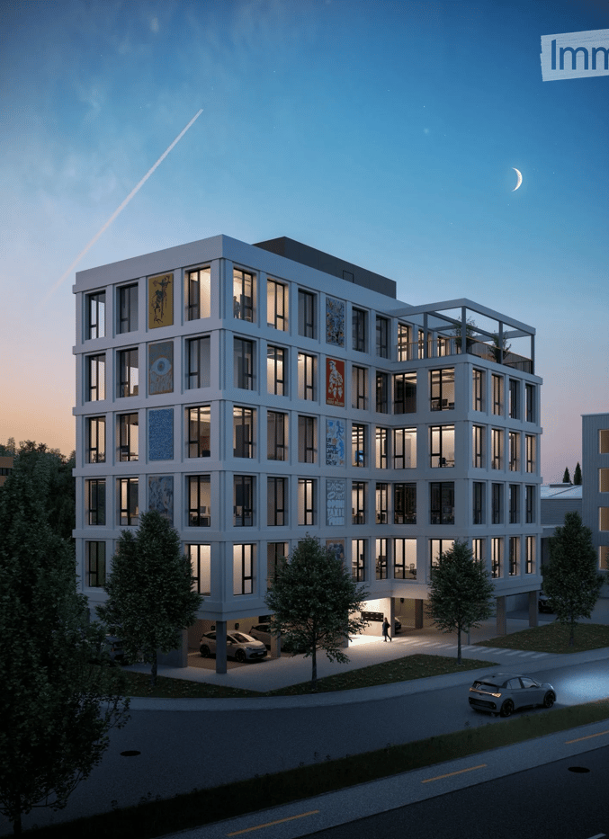 Building. Modern multi-story building with large windows, illuminated at night, featuring a garage and parking area.