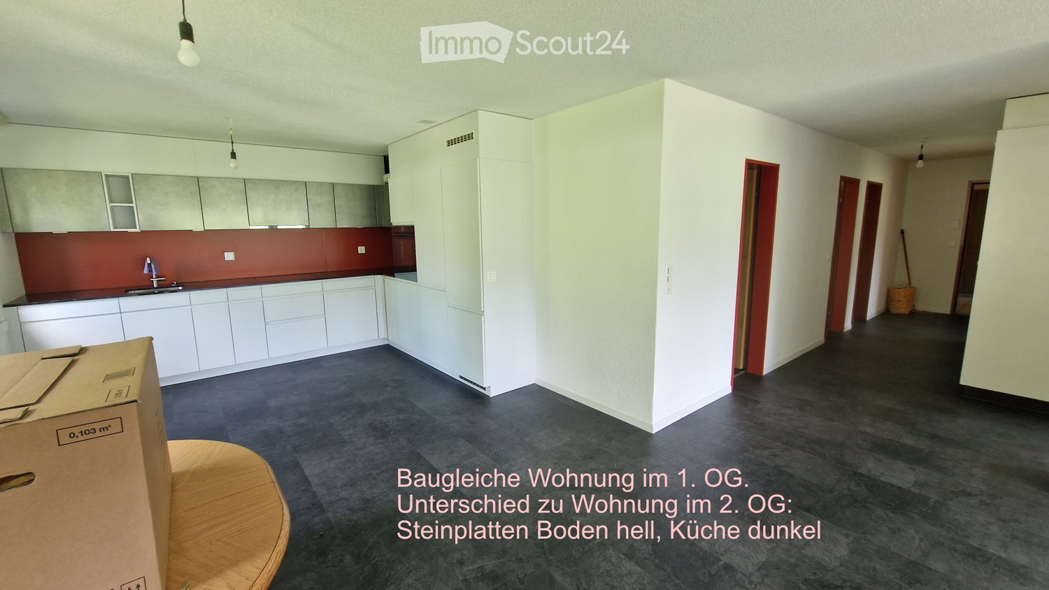 Unfurnished Room. Empty kitchen area with white cabinets, a red backsplash, and a dark tiled floor. No furniture or appliances are present.