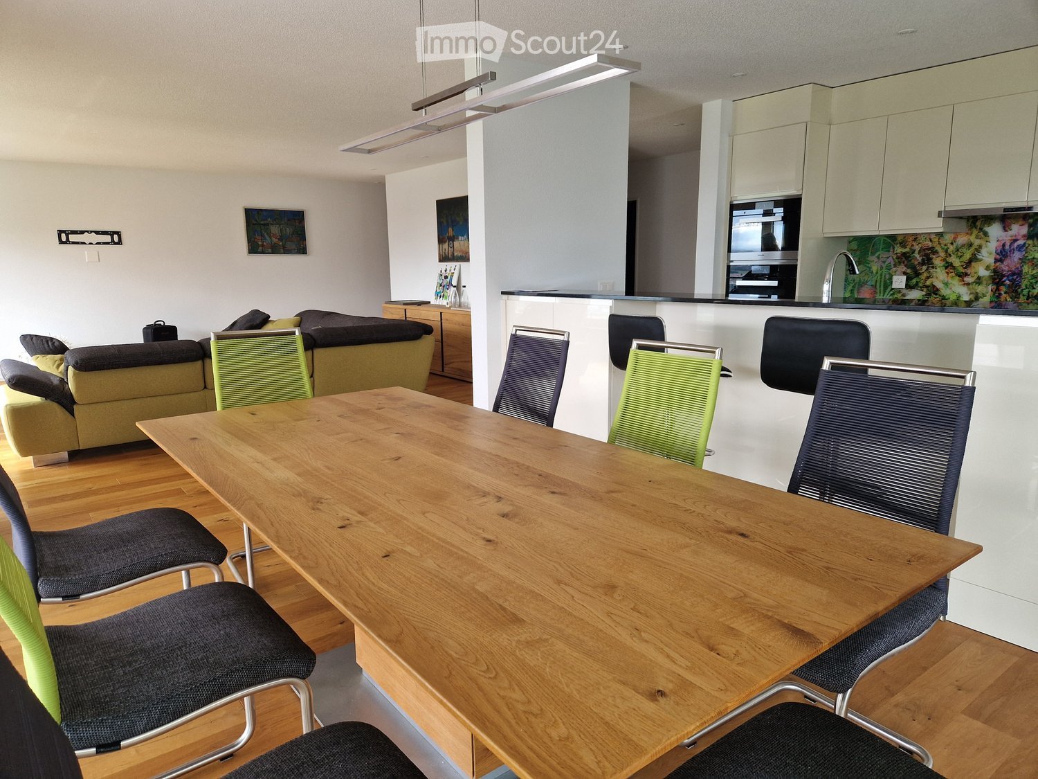 large table, modern chairs, modern kitchen island, hanging lamp, modern artwork