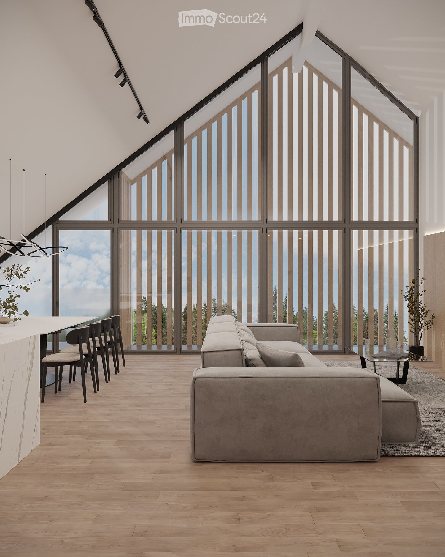 Modern living room with large windows offering a scenic view, featuring a grey sectional sofa, a glass coffee table, a white bar counter with bar stools, and a sleek pendant light fixture.