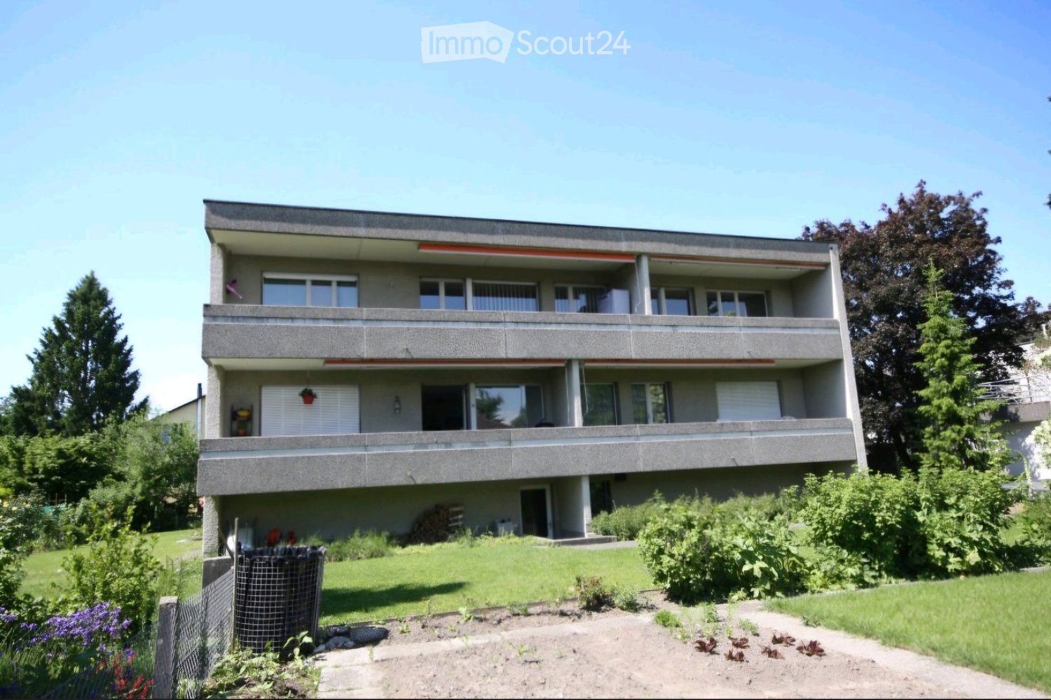 3 story apartment building, balconies, garden, trees