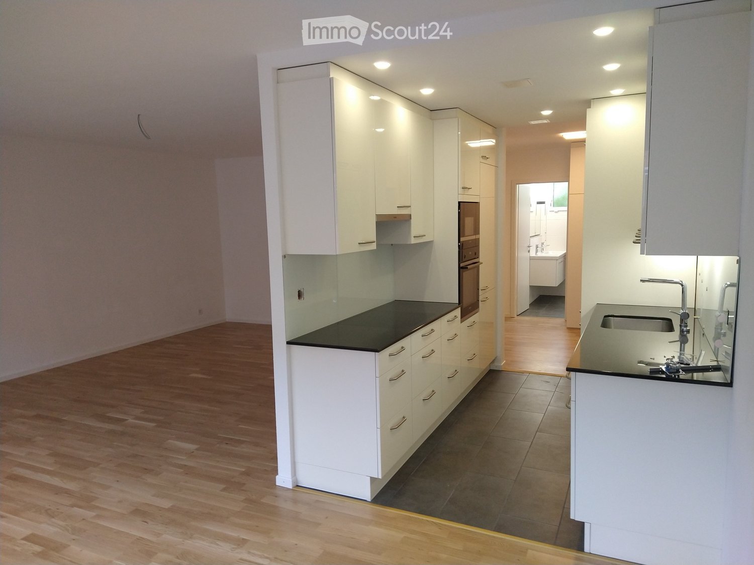 Kitchen. Modern kitchen with white cabinets, black countertops, and stainless steel appliances.