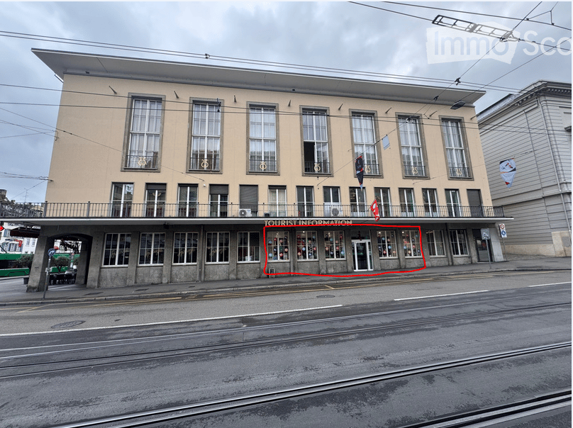 A multi-story building with a flat roof and large windows, featuring a sign that reads "TOURIST INFORMATION" above the entrance.