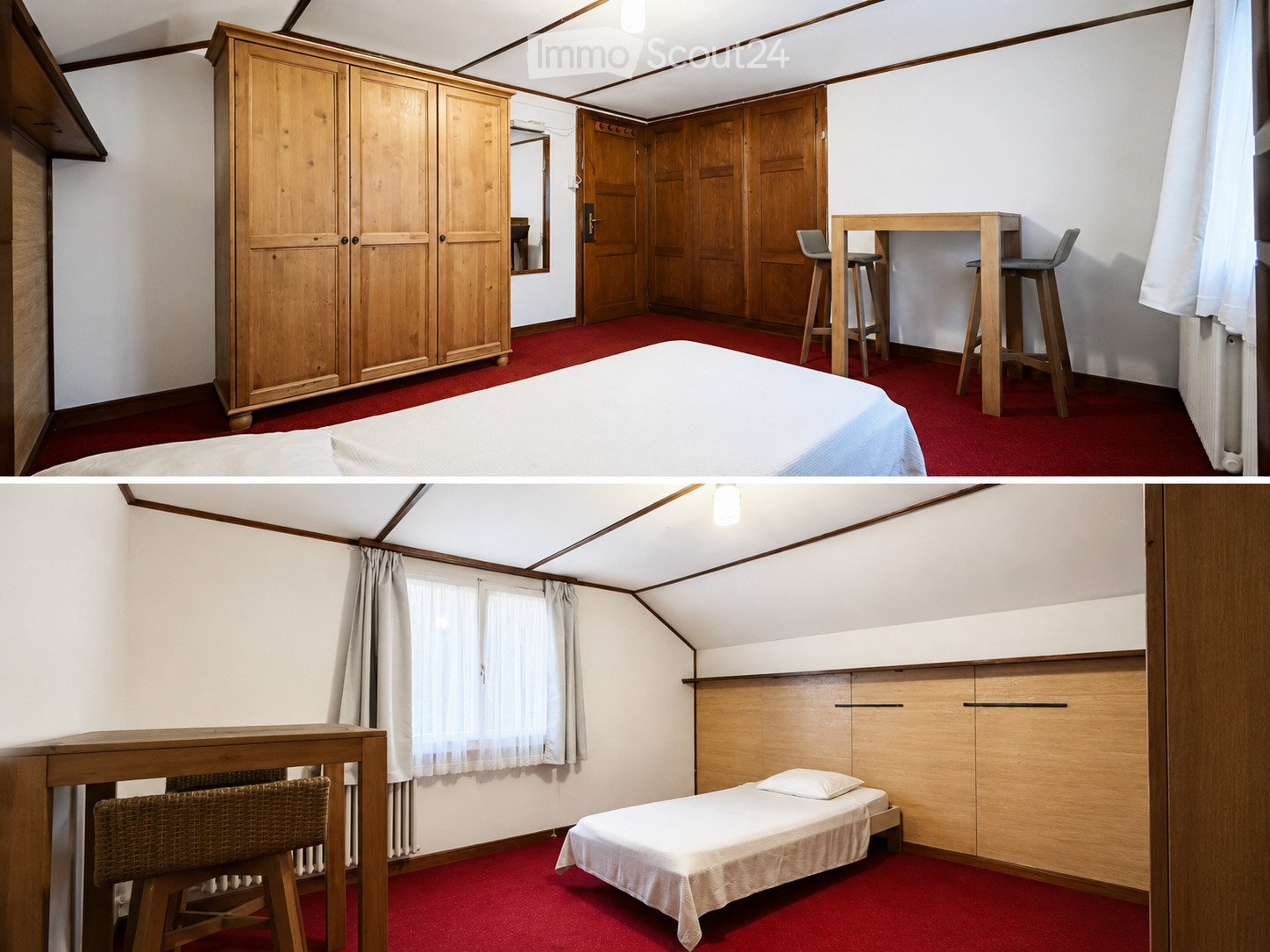 Cozy attic bedroom with red carpeting, white walls, wooden furniture including a large wardrobe, a small bed, a table with stools, and a wicker chair.