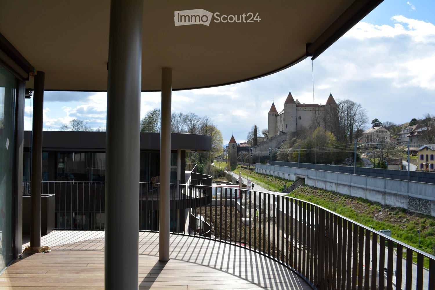 wooden floor, glass railing, spiral staircase, view of a castle and a road